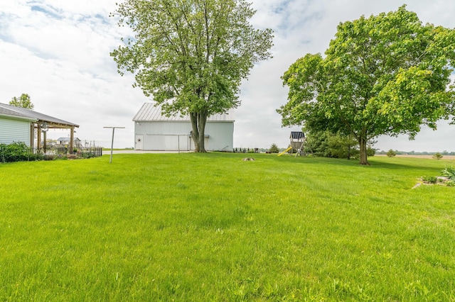 6010 Versailles Rd, Piqua, OH 45356 - view of green lawn featuring an outdoor structure and a pole building