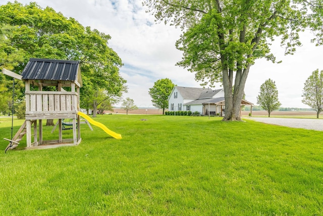 6010 Versailles Rd, Piqua, OH 45356 - view of green lawn with a playground