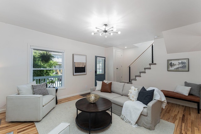 549 Hanford St, Columbus, OH 43206 - living area featuring stairway, light wood-style flooring, a chandelier, and healthy amount of natural light