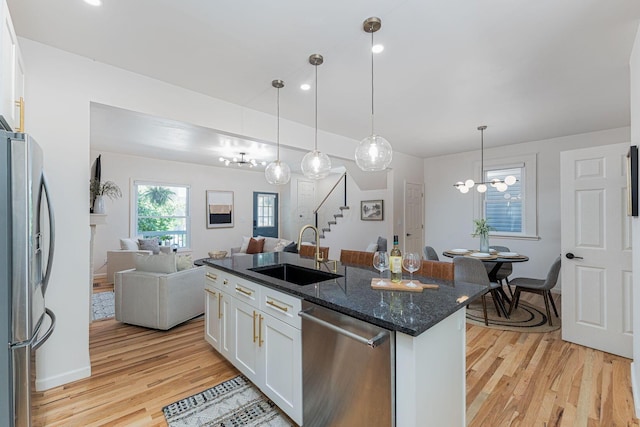 549 Hanford St, Columbus, OH 43206 - kitchen with a sink, appliances with stainless steel finishes, a chandelier, open floor plan, and light wood finished floors