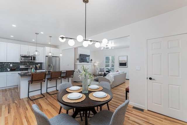 549 Hanford St, Columbus, OH 43206 - dining area with light wood-type flooring, recessed lighting, and a chandelier