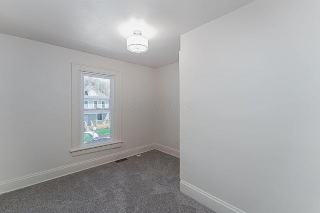 549 Hanford St, Columbus, OH 43206 - spare room featuring baseboards and dark colored carpet
