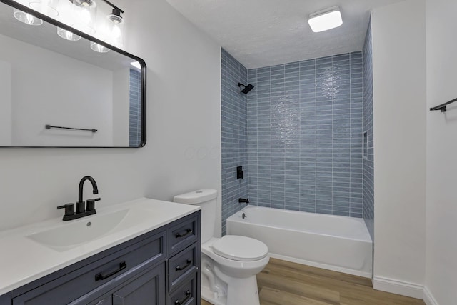 full bath with wood finished floors, toilet, bathing tub / shower combination, and vanity