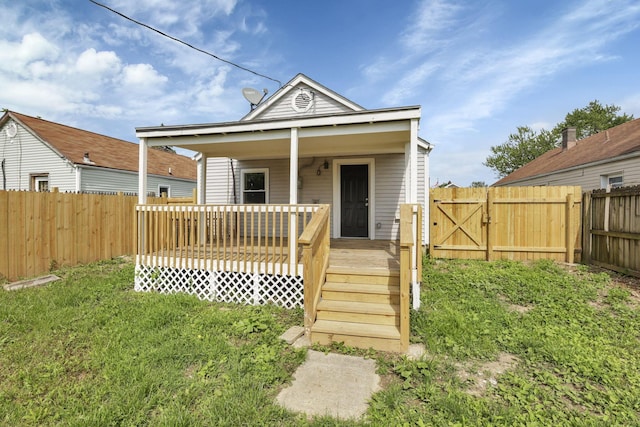 view of front of property featuring a fenced backyard and a gate