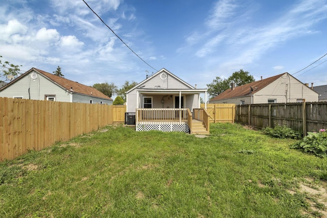 back of house with a porch and central AC unit