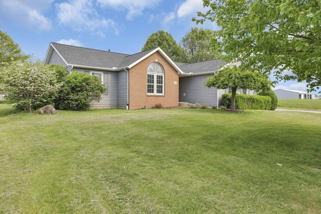 11708 Broad St, Millersport, OH 43046 - view of front of home with a front lawn, brick siding, and a shingled roof