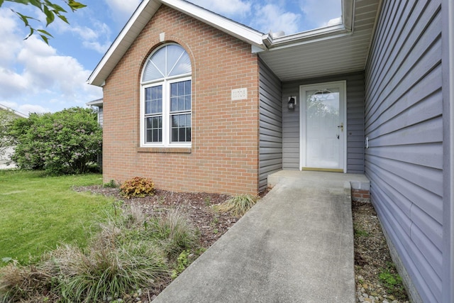 11708 Broad St, Millersport, OH 43046 - view of exterior entry featuring brick siding and a yard