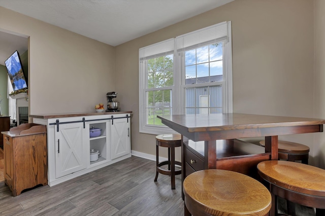 11708 Broad St, Millersport, OH 43046 - kitchen with wood finished floors, white cabinets, and baseboards
