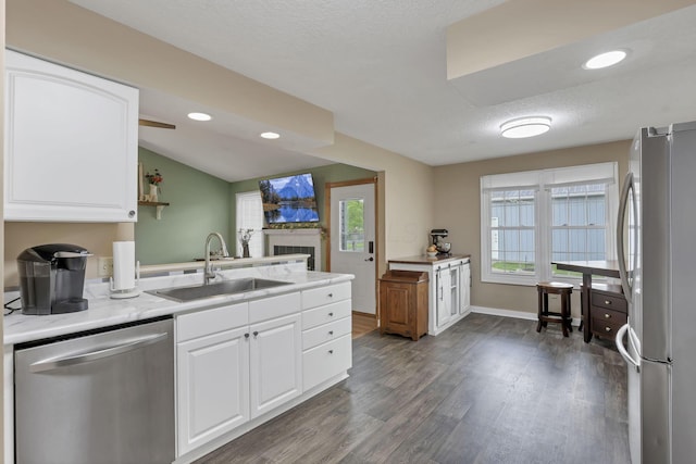 11708 Broad St, Millersport, OH 43046 - kitchen with appliances with stainless steel finishes, a sink, a fireplace, dark wood-type flooring, and vaulted ceiling