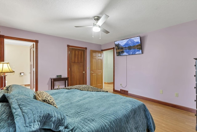 11708 Broad St, Millersport, OH 43046 - bedroom with light wood-type flooring, baseboards, a ceiling fan, and a textured ceiling