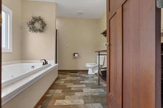 11708 Broad St, Millersport, OH 43046 - full bath with toilet, a tub with jets, and baseboards
