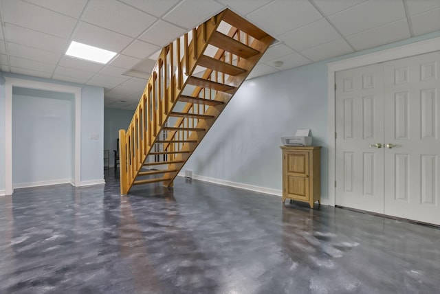 11708 Broad St, Millersport, OH 43046 - basement with stairway, a paneled ceiling, and baseboards