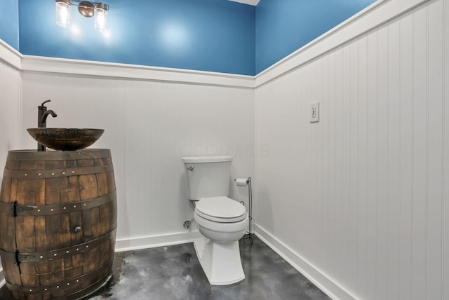 11708 Broad St, Millersport, OH 43046 - half bath featuring concrete flooring, toilet, baseboards, and vanity