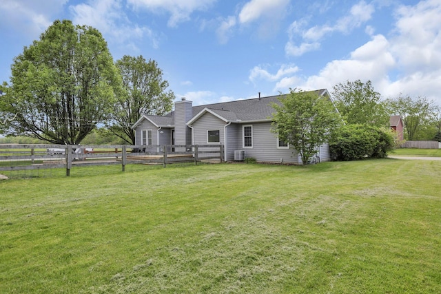 11708 Broad St, Millersport, OH 43046 - back of property featuring a chimney, central air condition unit, and a shingled roof