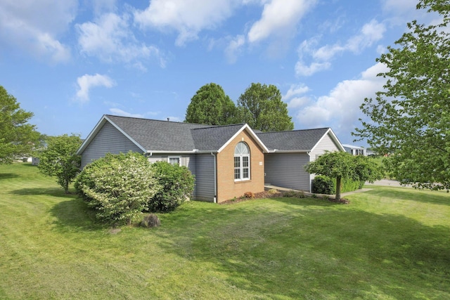 11708 Broad St, Millersport, OH 43046 - view of side of home featuring a lawn, roof with shingles, and brick siding