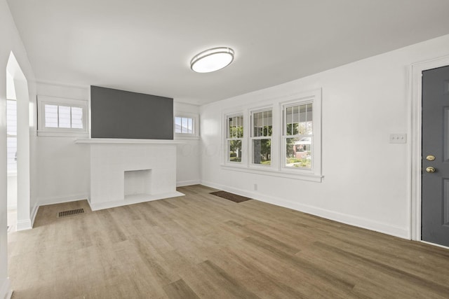 436 Nashoba Ave, Columbus, OH 43223 - unfurnished living room with wood finished floors, baseboards, and a brick fireplace