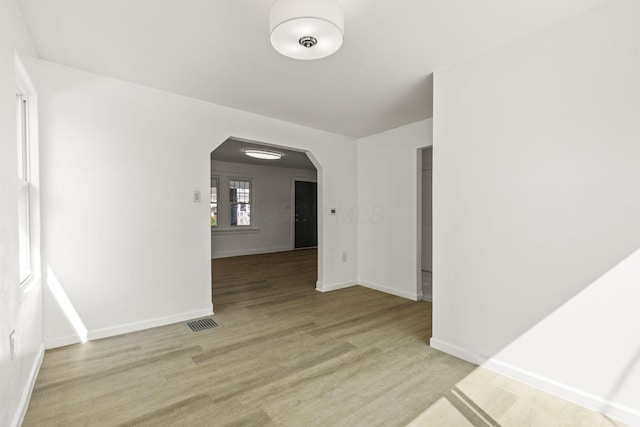 436 Nashoba Ave, Columbus, OH 43223 - unfurnished room with arched walkways, baseboards, and light wood-style floors