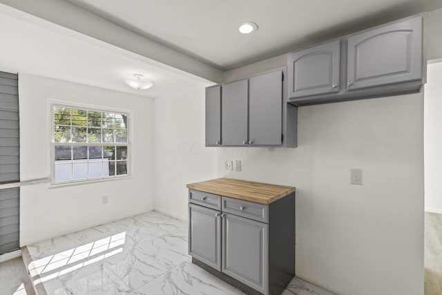 436 Nashoba Ave, Columbus, OH 43223 - kitchen with gray cabinets, light marble finish floors, butcher block counters, recessed lighting, and baseboards