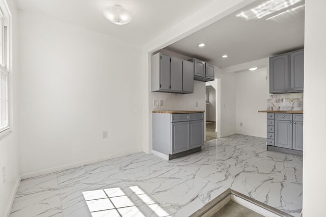 436 Nashoba Ave, Columbus, OH 43223 - kitchen with gray cabinets, light marble finish flooring, recessed lighting, baseboards, and wooden counters