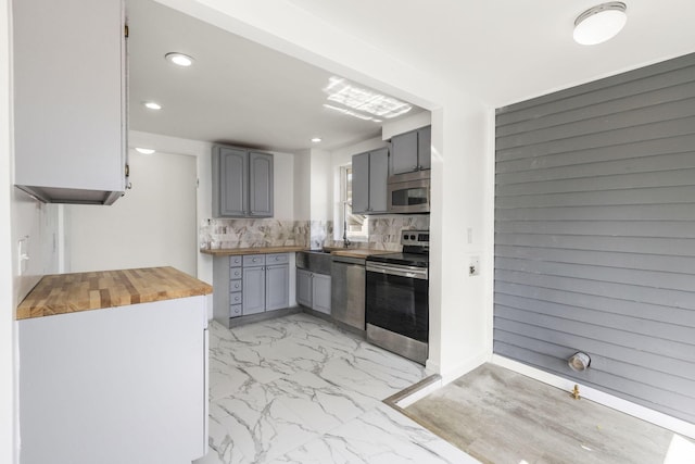 436 Nashoba Ave, Columbus, OH 43223 - kitchen featuring appliances with stainless steel finishes, butcher block countertops, gray cabinetry, light marble finish floors, and recessed lighting