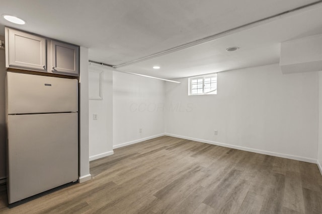 436 Nashoba Ave, Columbus, OH 43223 - below grade area featuring freestanding refrigerator, wood finished floors, baseboards, and recessed lighting