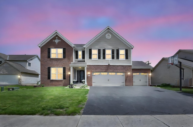 210 Carson Ct, Pickerington, OH 43147 - view of front of home featuring asphalt driveway, a front yard, brick siding, and an attached garage
