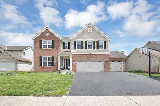 210 Carson Ct, Pickerington, OH 43147 - view of front of house with brick siding, asphalt driveway, a front lawn, and an attached garage