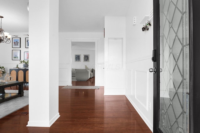 210 Carson Ct, Pickerington, OH 43147 - hall featuring wood finished floors, a chandelier, and a decorative wall