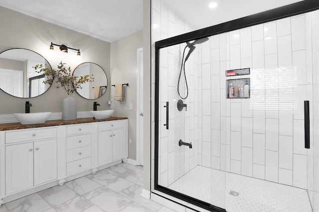 210 Carson Ct, Pickerington, OH 43147 - bathroom featuring marble look tiles, a stall shower, double vanity, and baseboards