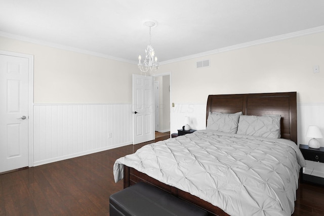 210 Carson Ct, Pickerington, OH 43147 - bedroom with dark wood-style floors, a chandelier, ornamental molding, and a wainscoted wall