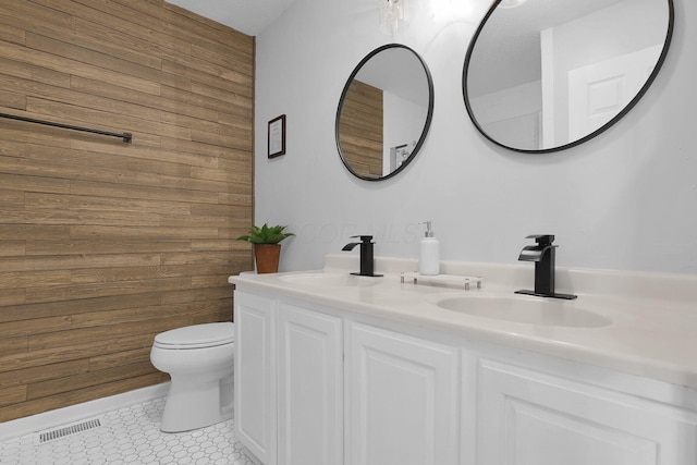 210 Carson Ct, Pickerington, OH 43147 - full bathroom with wooden walls, toilet, and double vanity