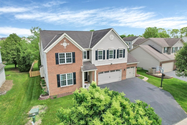 210 Carson Ct, Pickerington, OH 43147 - view of front of property featuring brick siding, driveway, central air condition unit, a front yard, and roof with shingles