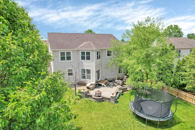 210 Carson Ct, Pickerington, OH 43147 - rear view of house featuring a fire pit, a trampoline, and a patio