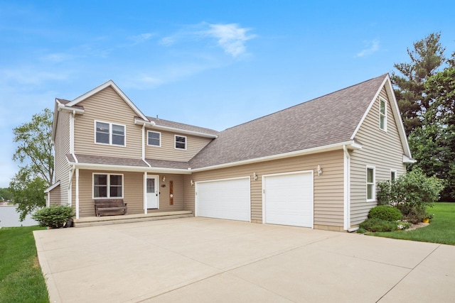 1380 E Choctaw Dr, London, OH 43140 - view of front of property featuring a garage, concrete driveway, a shingled roof, a front lawn, and a porch