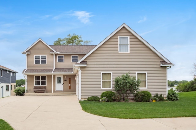 1380 E Choctaw Dr, London, OH 43140 - traditional-style house featuring a front yard, concrete driveway, covered porch, and roof with shingles