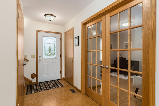 1380 E Choctaw Dr, London, OH 43140 - entryway featuring french doors, wood finished floors, and baseboards