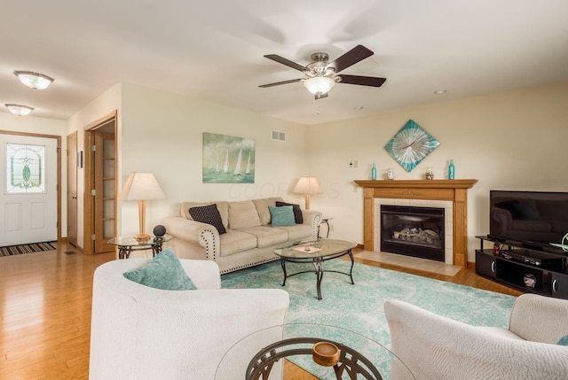 1380 E Choctaw Dr, London, OH 43140 - living room with wood finished floors, ceiling fan, and a fireplace