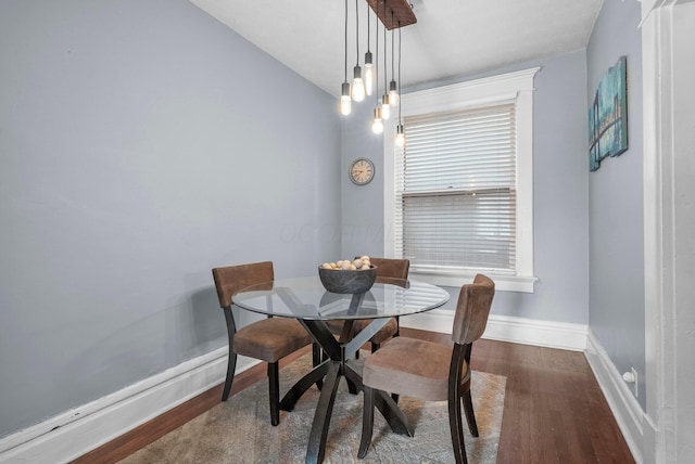 915 Dennison Ave, Columbus, OH 43201 - dining room featuring wood finished floors, baseboards, and vaulted ceiling