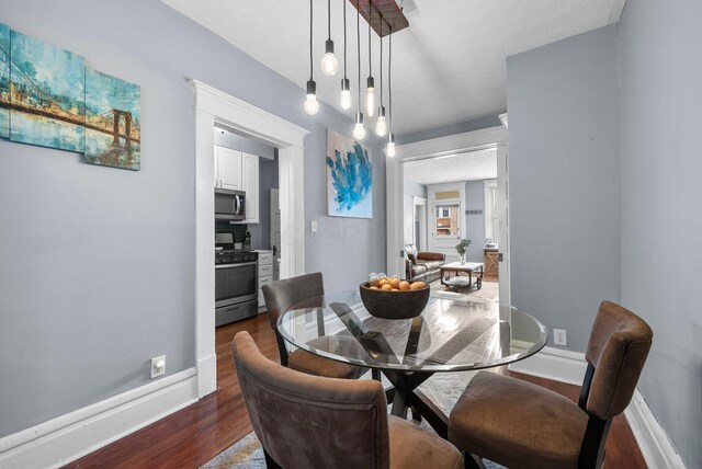 915 Dennison Ave, Columbus, OH 43201 - dining area featuring dark wood-type flooring and baseboards
