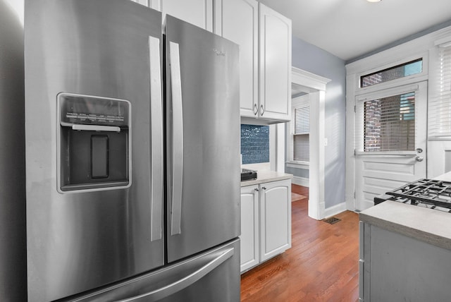 915 Dennison Ave, Columbus, OH 43201 - kitchen with stainless steel fridge with ice dispenser, white cabinets, wood finished floors, and light countertops