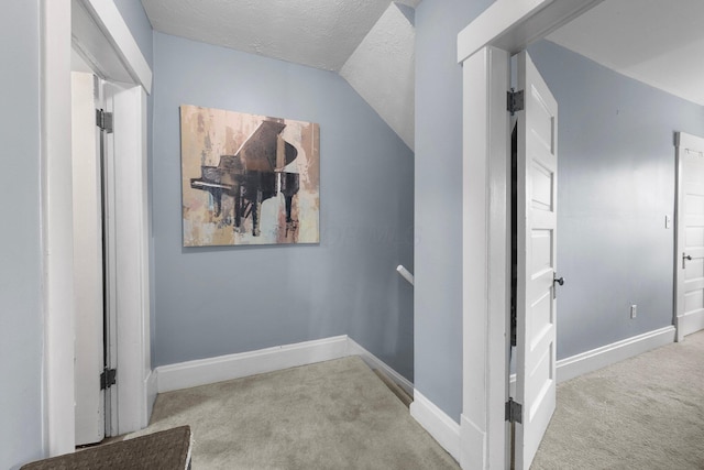 915 Dennison Ave, Columbus, OH 43201 - hallway with carpet, baseboards, a textured ceiling, and lofted ceiling