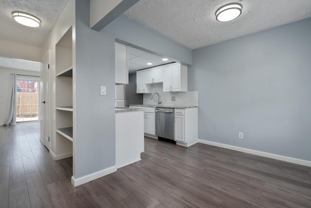 143 Tarryton Ct W Unit 24E, Columbus, OH 43228 - kitchen featuring appliances with stainless steel finishes, a textured ceiling, dark wood-style flooring, white cabinets, and baseboards