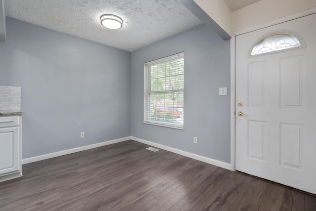 143 Tarryton Ct W Unit 24E, Columbus, OH 43228 - entryway with dark wood finished floors, baseboards, and a textured ceiling