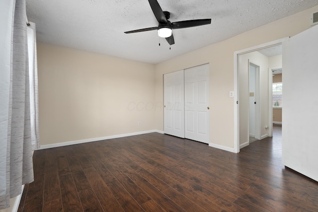 143 Tarryton Ct W Unit 24E, Columbus, OH 43228 - unfurnished bedroom with dark wood-style flooring, a closet, baseboards, ceiling fan, and a textured ceiling