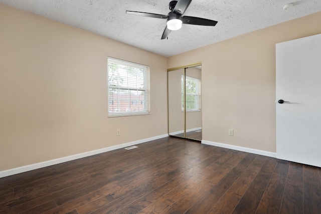 143 Tarryton Ct W Unit 24E, Columbus, OH 43228 - unfurnished bedroom featuring a textured ceiling, hardwood / wood-style flooring, a closet, baseboards, and ceiling fan
