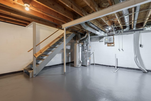 143 Tarryton Ct W Unit 24E, Columbus, OH 43228 - unfinished below grade area featuring gas water heater, stairway, and concrete block wall