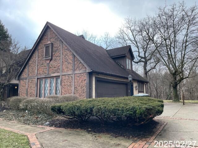 view of side of home featuring an attached garage