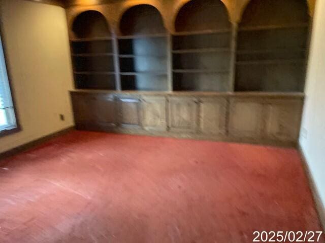 carpeted spare room with baseboards