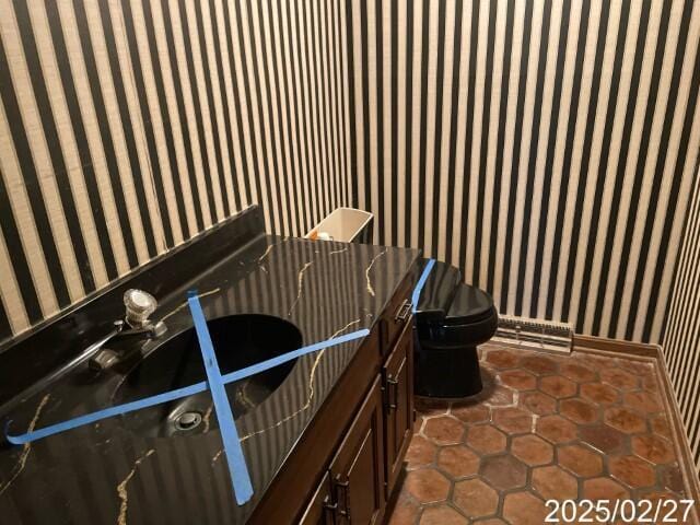 interior space featuring wallpapered walls and dark tile patterned floors