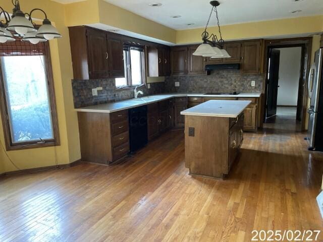 kitchen featuring a chandelier, light countertops, and wood finished floors